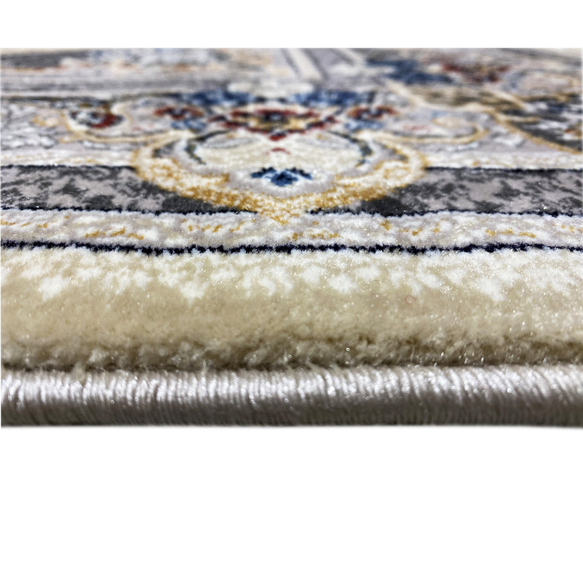 Teppich-Detail mit floraler Bordüre in Beige, Blau und Dunkelblau sowie Fransen