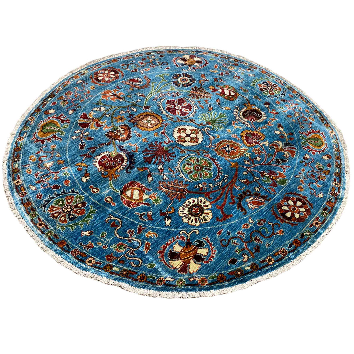 Blauer runder Wollteppich mit mehrfarbigem Blumenornament und geschwungener Musterkante