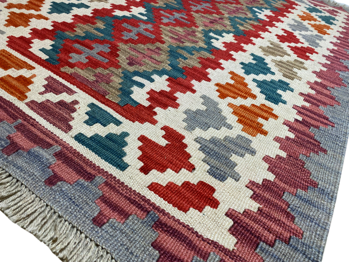 Bunter Kelim Qashqai Teppich mit geometrischem Muster in Rot, Blau, Grün und Beige