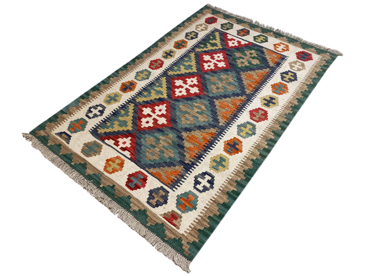 Kelim-Teppich mit geometrischem Muster in Grün- und Weißtönen, mit Fransen