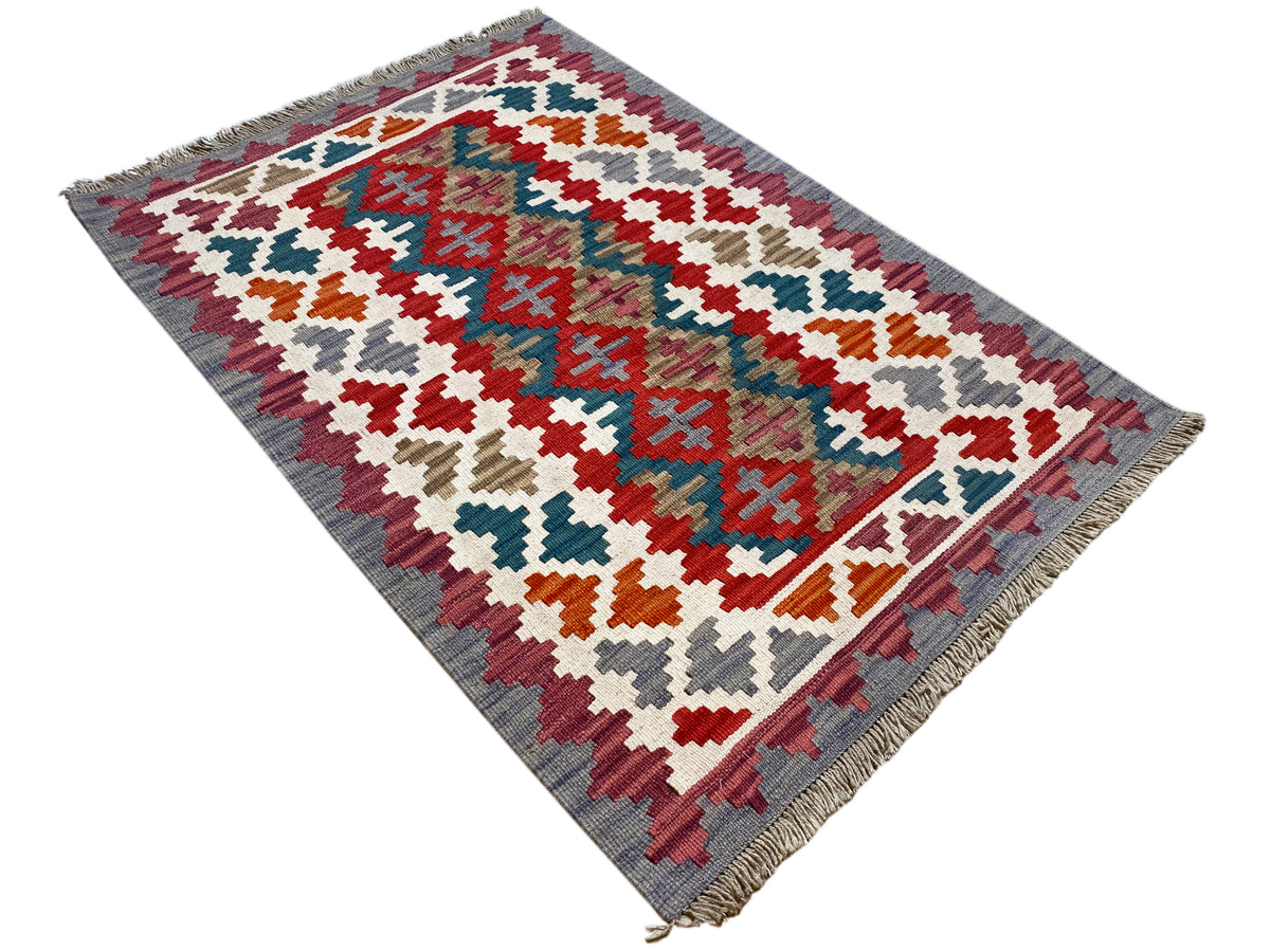 Mehrfarbiger Kelim Teppich mit geometrischem Kreuzmuster und Fransen am Rand