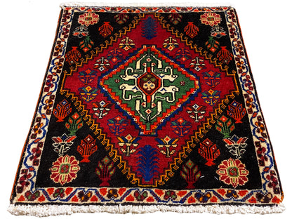 Poshti-Teppich 56x56 cm in Draufsicht, schwarzer Hintergrund mit rotem Randmuster